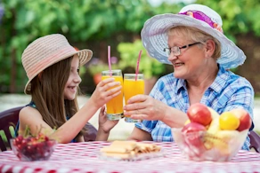 Life Assure Senior Woman Sitting In Chair And Laughing With Caregiver Nurse Blog